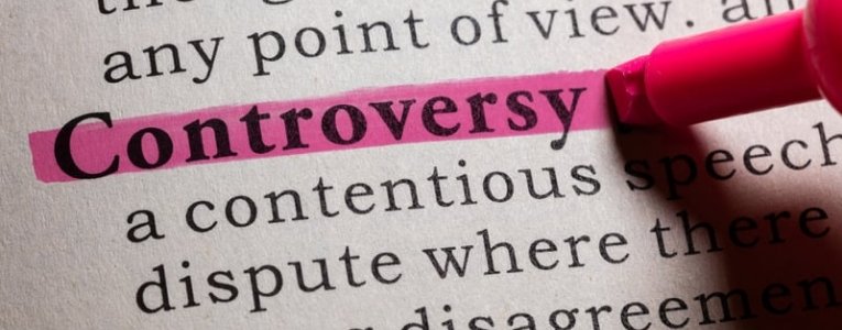 Controversy word written in a book that highlighted, the concept of describing controversy