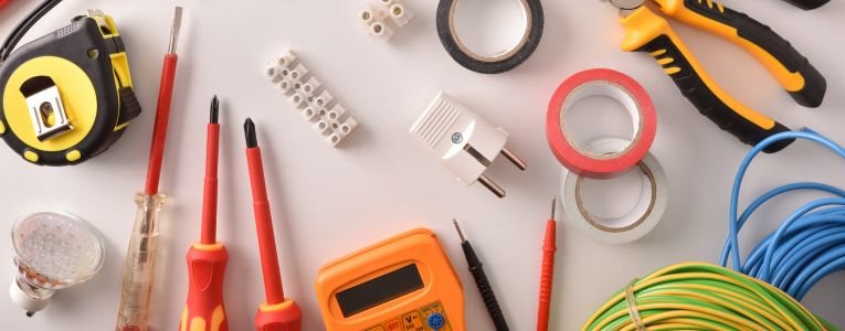 Tools and electrical material on a white table top general