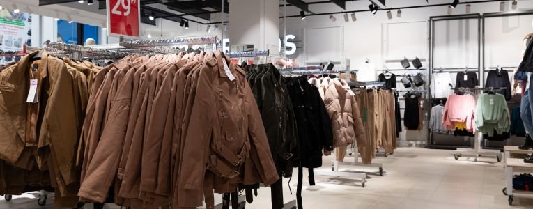 interior of a store selling stylish inexpensive clothes, jackets on hangers in a wide range