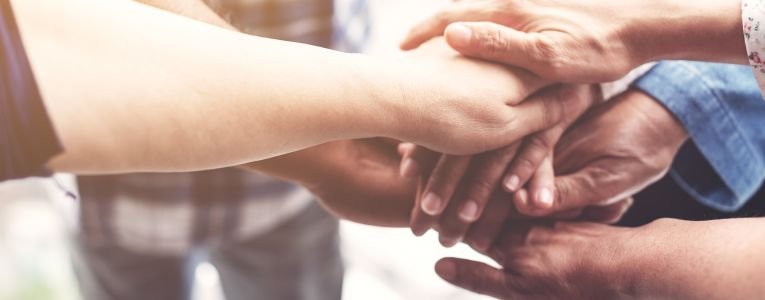 People hand assemble as a connection meeting teamwork concept. Group of people colleague assembly hands as a business or work achievement. Man and women touch each other hands. Teamwork conceptual