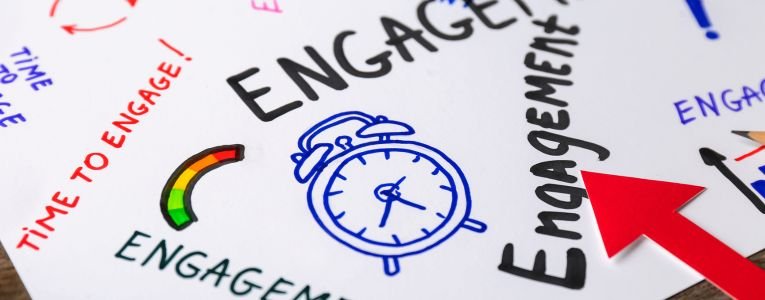 Sheet of Paper with Written Words ENGAGEMENT on Table