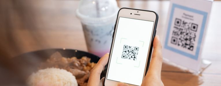 Woman use smartphone to scan QR code for order menu in cafe rest